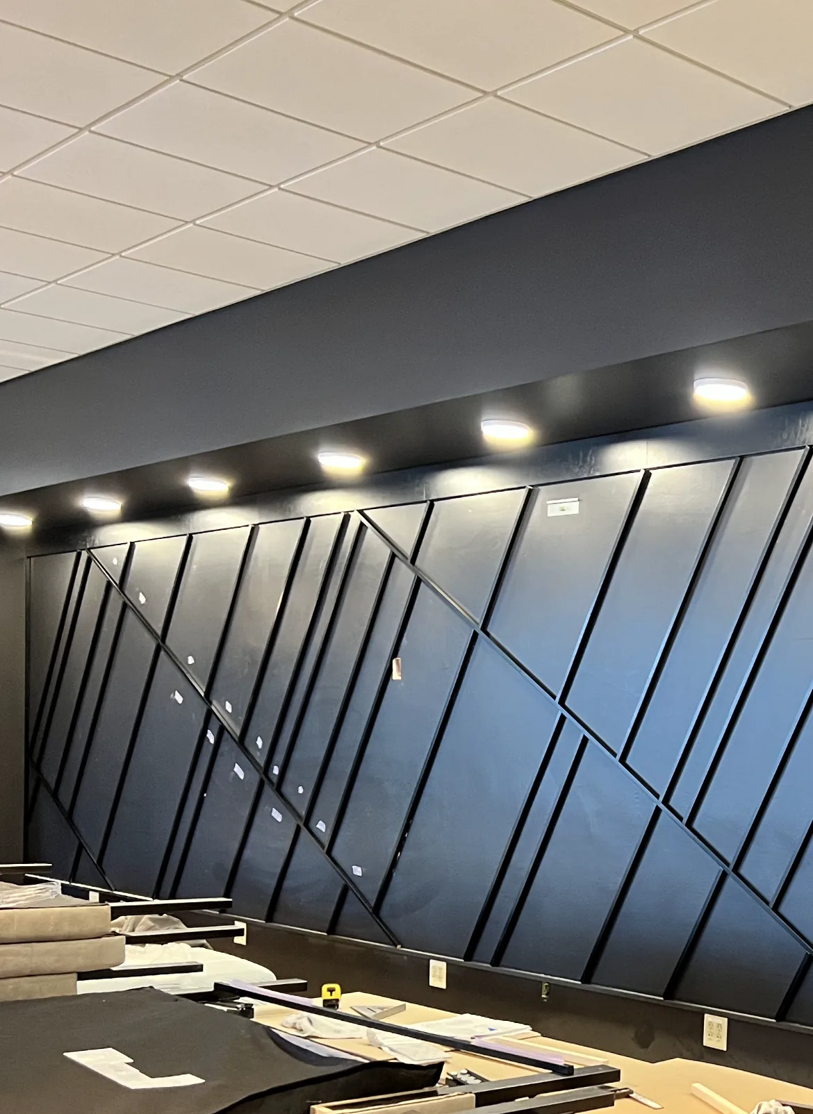 Black diagonal batten feature wall with lit soffit