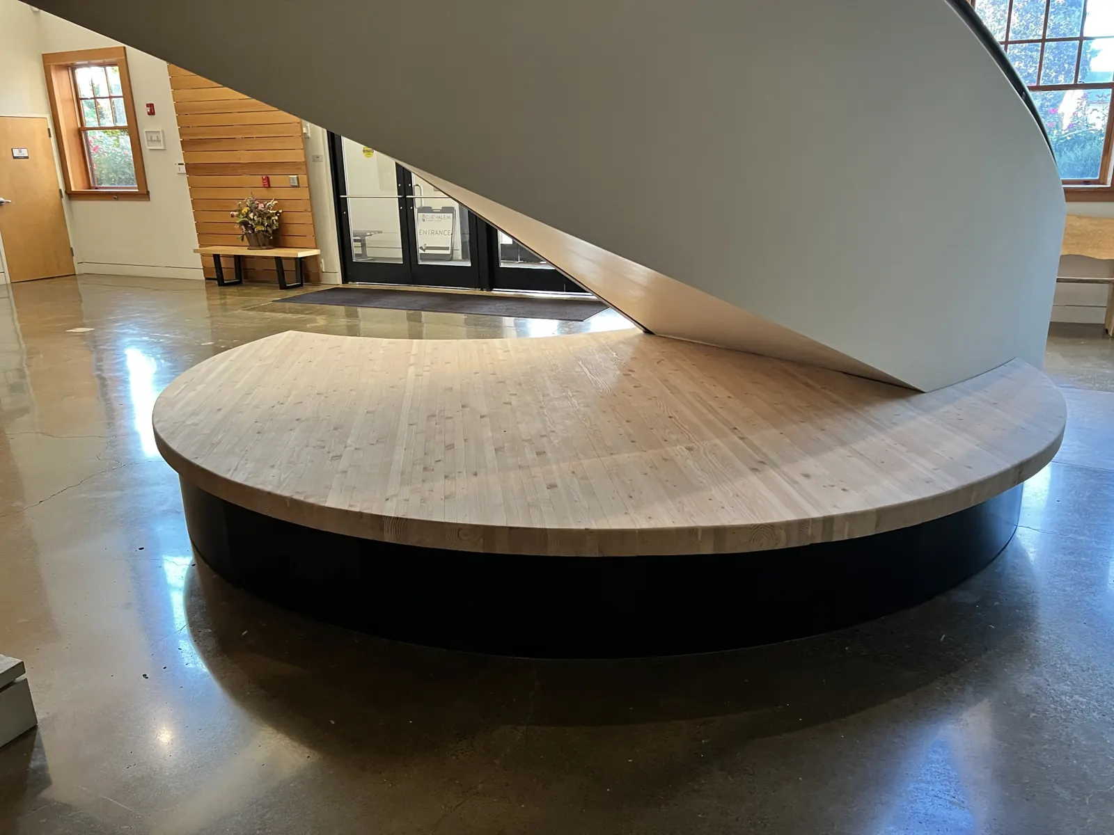 Curved stage with a hardwood tambour front under the staircase