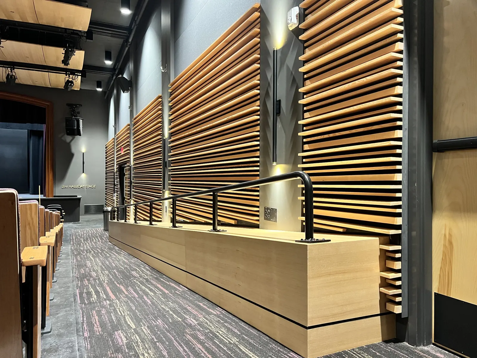 Wood slat wall and counter along a lobby
