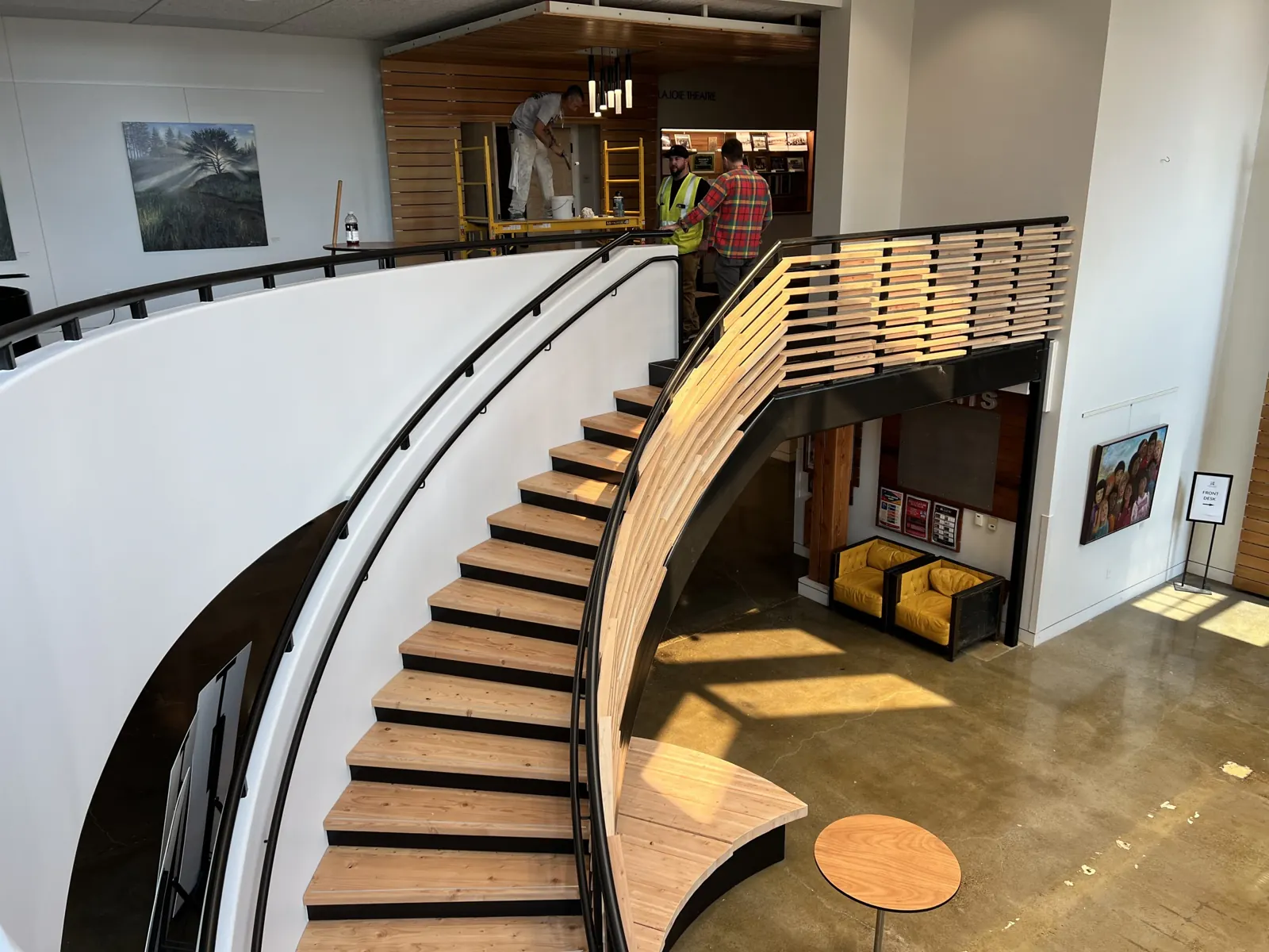 Curved staircase with custom wood slat railing