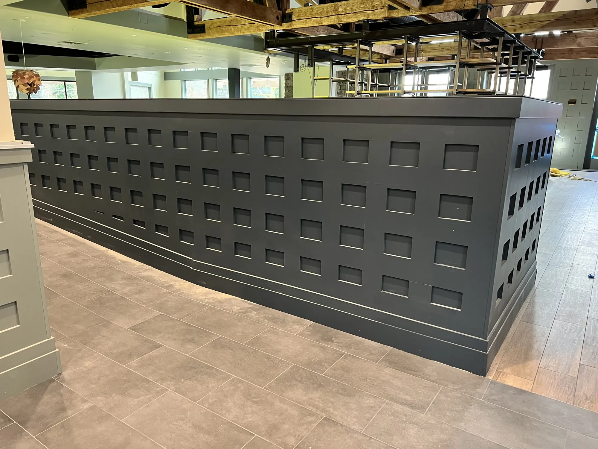 Long painted bar front with a recessed square pattern