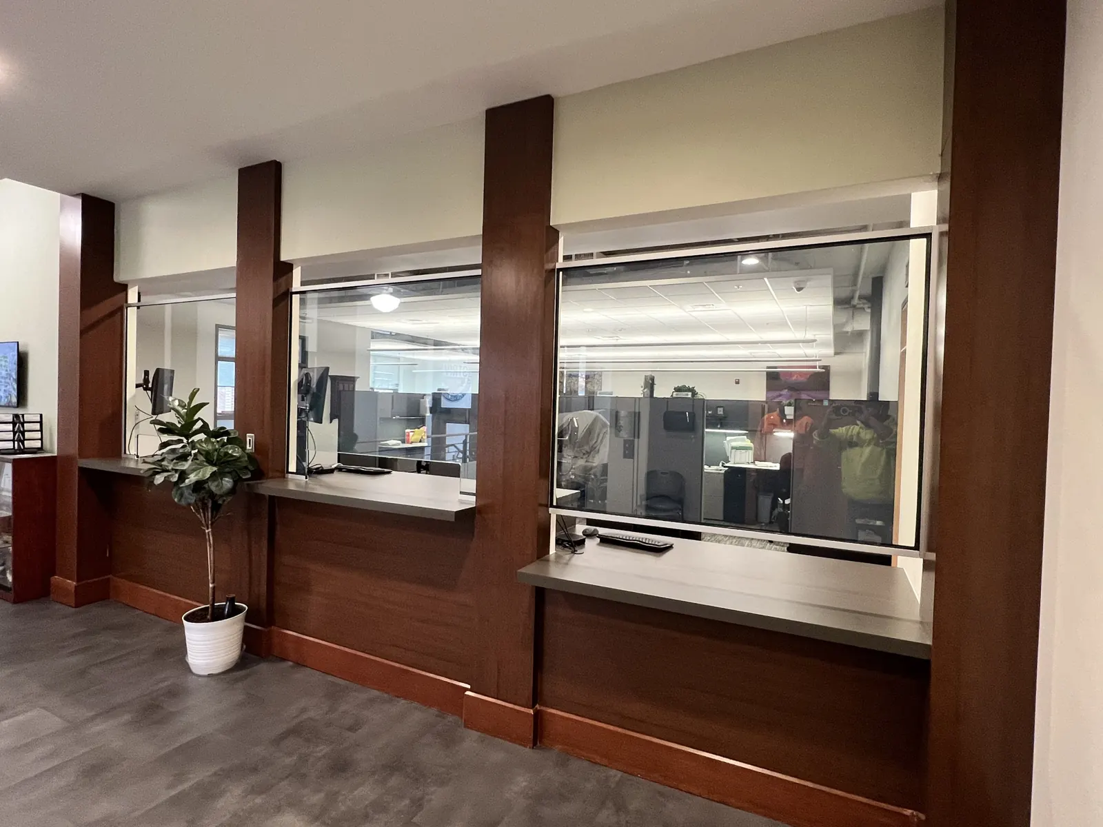 Transaction windows trimmed in wood with counters below