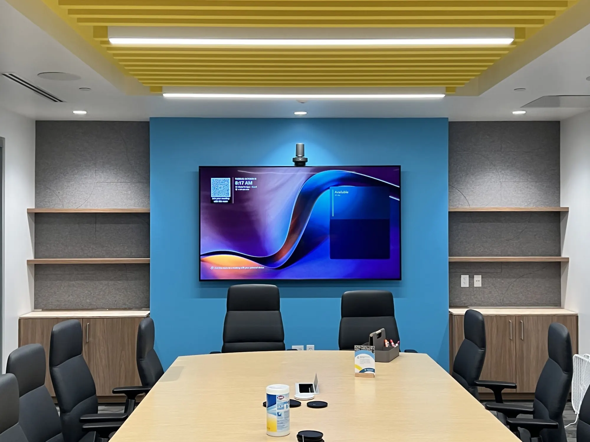 Conference room with built-in cabinets and shelves on both sides of a feature wall