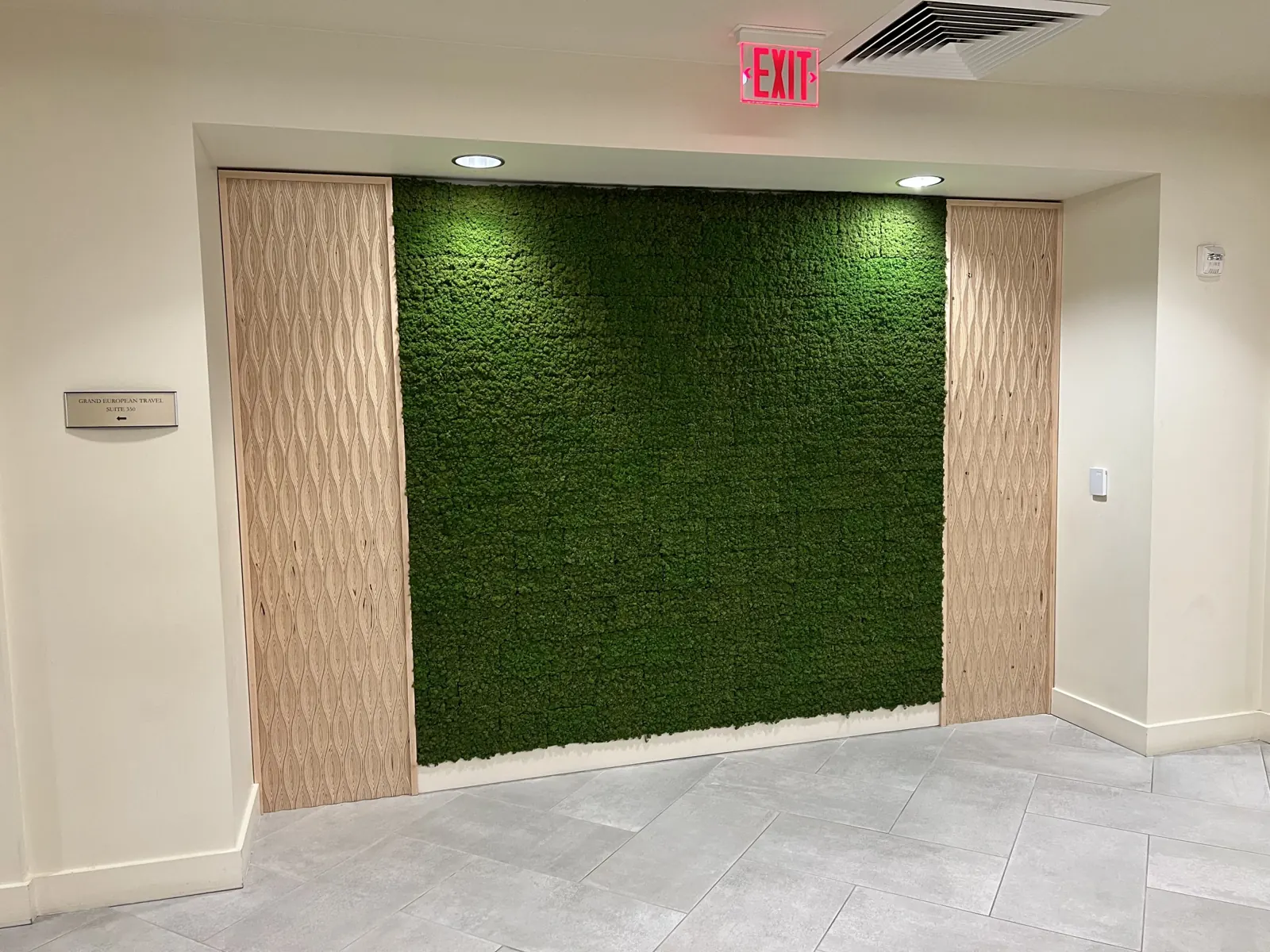 Textured wood panels framing a moss wall